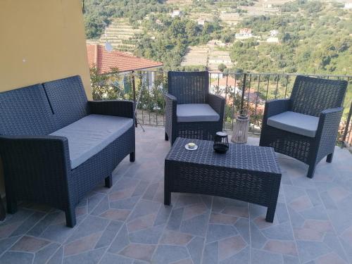 a group of chairs and a table on a balcony at La casa di Trilly in Sanremo