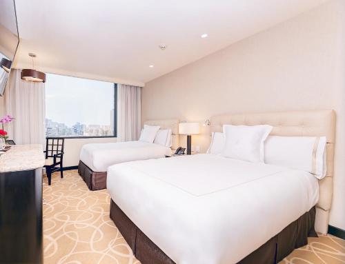 a hotel room with two beds and a window at Hotel Marquis Reforma in Mexico City