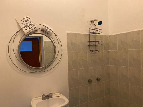 a bathroom with a mirror and a sink at Mil Mascaras in Oaxaca City
