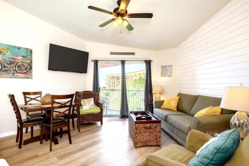 ein Wohnzimmer mit einer Couch und einem Tisch in der Unterkunft Shelly Sands HeatedPool & HotTub Private Beach in Destin