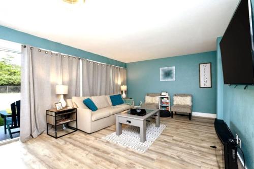 a living room with a couch and a table at Cool Azul 3 Community Pools Central Destin in Destin