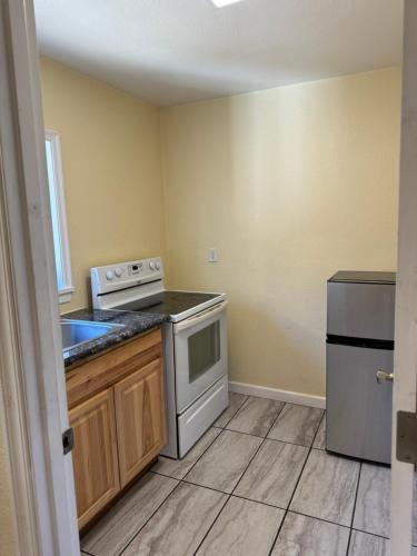 a small kitchen with a stove and a sink at Relax Inn of Medford in Medford