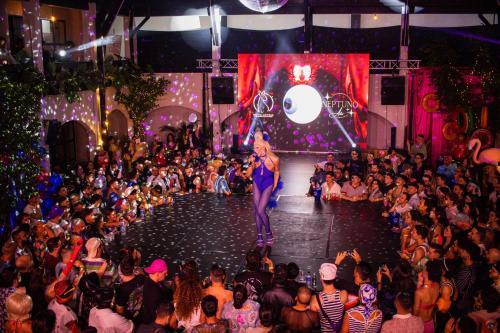 a woman standing on a stage in front of a crowd at Socialtel Medellin in Medellín