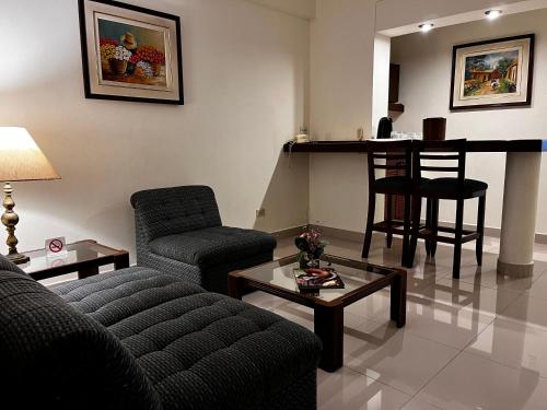 a living room with a couch and a table at Hotel Boulevard in Lima