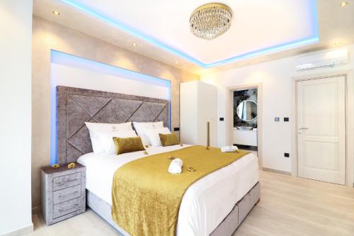 a bedroom with a large bed with a large headboard at Villa Golden Lion in Primošten