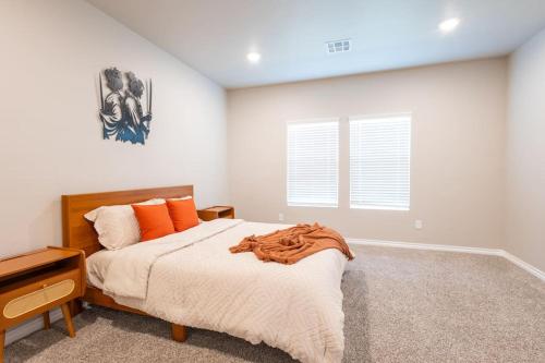 a bedroom with a large bed with orange pillows at Mongou Vacation Home in Yukon