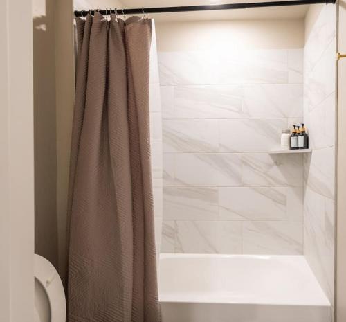 a bathroom with a shower with a shower curtain at Mongou Vacation Home in Yukon