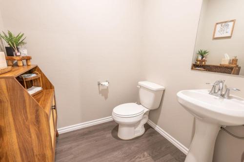 a bathroom with a white toilet and a sink at Mongou Vacation Home in Yukon