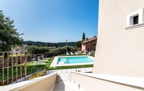 a villa with a swimming pool and a balcony at Nice Home In Costermano Sul Garda in Costermano sul Garda