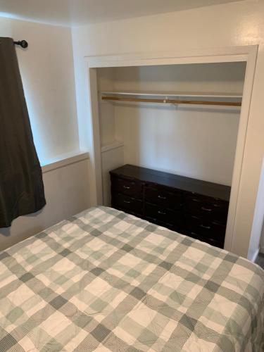a bedroom with a bed and a dresser at 410 e45th 2 bedroom apartment in Anchorage