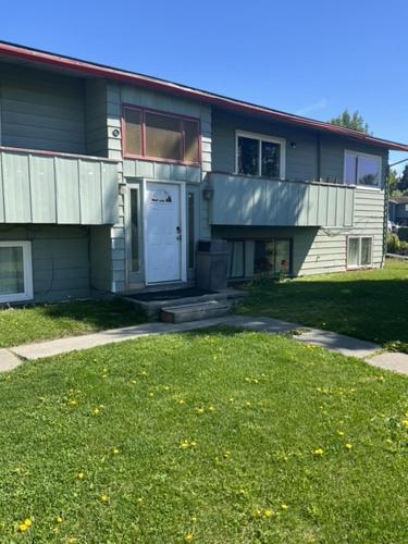 a house with a lawn in front of it at 410 e45th 2 bedroom apartment in Anchorage