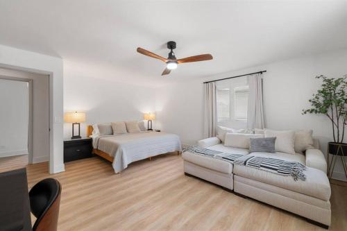 a living room with a couch and a bed at New Bensenville Home by O'Hare Airport with Indoor Pool, Sauna, and Arcade in Bensenville