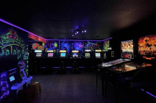 a gaming room with lots of slot machines at New Bensenville Home by O'Hare Airport with Indoor Pool, Sauna, and Arcade in Bensenville