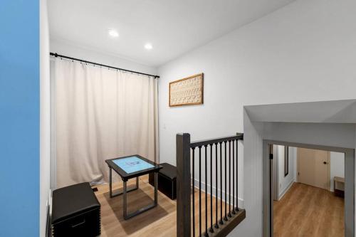 a room with a staircase with a table and a window at New Bensenville Home by O'Hare Airport with Indoor Pool, Sauna, and Arcade in Bensenville