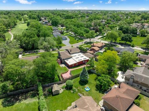 an aerial view of a residential neighborhood with houses at New Bensenville Home by O'Hare Airport with Indoor Pool, Sauna, and Arcade in Bensenville