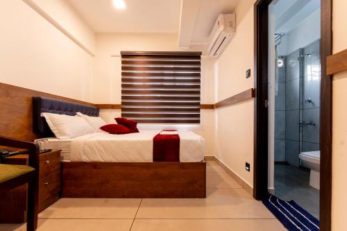 a bedroom with a bed and a shower and a tub at Sapphire Business Suites in Ernakulam