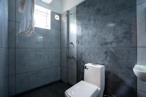 a bathroom with a toilet and a sink at Sapphire Business Suites in Ernakulam