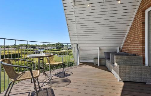 a patio with a table and chairs on a deck at Gorgeous Home In Øster Assels With Wifi in Øster Assels