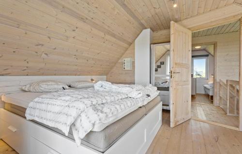 a bed in a room with a wooden ceiling at Gorgeous Home In Øster Assels With Wifi in Øster Assels