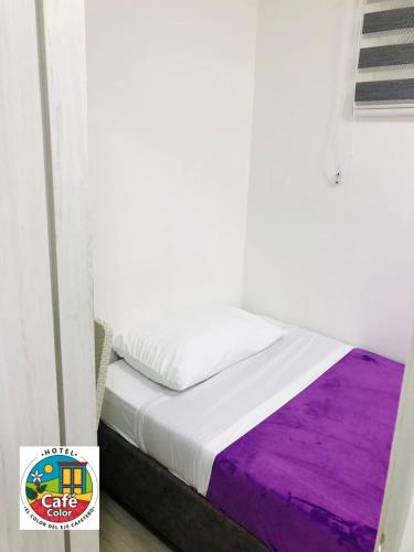 a bed in a room with a purple mattress at Hotel Café Color in Armenia