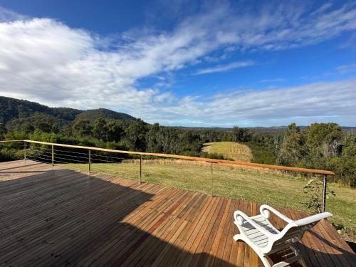 two white chairs sitting on top of a wooden deck at Valley View in Possum Brush