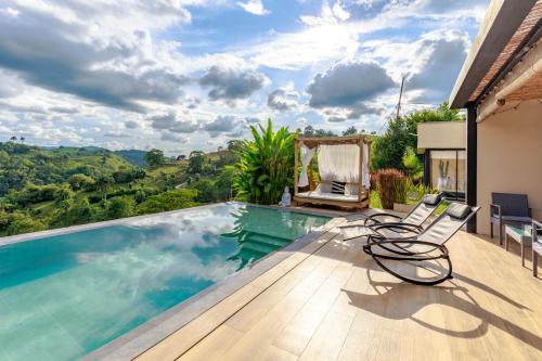 a villa with a swimming pool with a view at Casa Río Quindío in La Tebaida