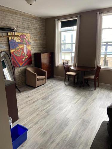 a room with a desk and chairs and a table at The Avonlea Inn in Stratford