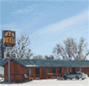 a gas station with a car parked in front of it at Western Motel Ranchester in Ranchester