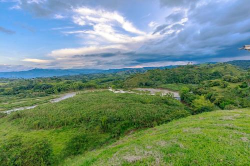 an aerial view of a river in a field at Casa Río Quindío in La Tebaida