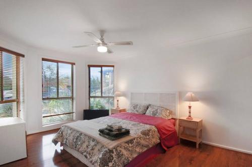 a bedroom with a bed and a ceiling fan at Spacious Seabrook Hideaway Near the Bay in Williams Landing