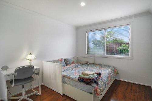 a bedroom with a bed and a desk and a window at Spacious Seabrook Hideaway Near the Bay in Williams Landing