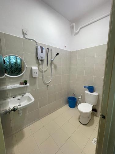 a bathroom with a shower and a toilet and a sink at NaiS Homestay in Kampong Alor Gajah