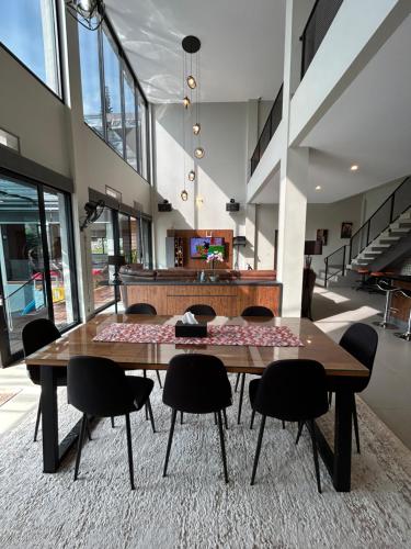 a large dining room with a table and chairs at Royal Hill Villa Cisarua Puncak in Puncak