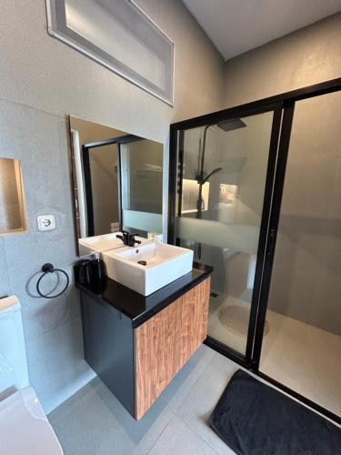 a bathroom with a white sink and a mirror at Royal Hill Villa Cisarua Puncak in Puncak