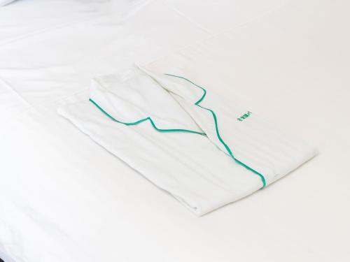 a white shirt with a blue line on it at Tabist Sasebo Palace Hotel in Sasebo