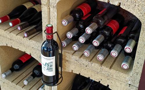 a bunch of wine bottles in a cellar at Logis Grand Hotel Pelisson in Nontron