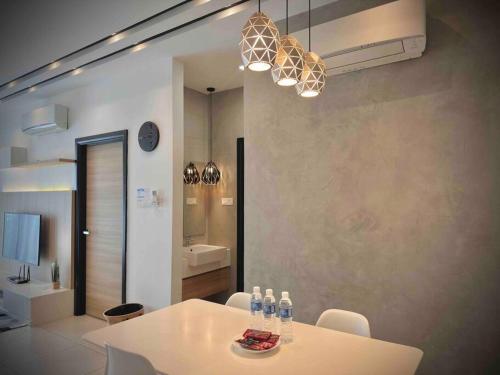 a white table and chairs in a room with a bathroom at Jk DeLOFTS 03 6Pax 150Mbps 2BedR 2BathR 1Carpark in Kuching