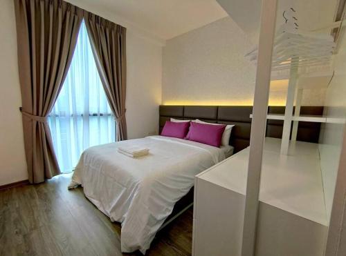a bedroom with a bed with pink pillows and a window at Jk DeLOFTS 03 6Pax 150Mbps 2BedR 2BathR 1Carpark in Kuching