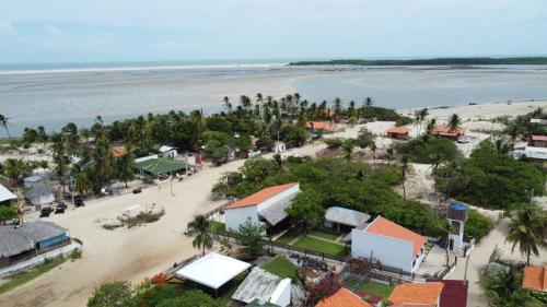 an aerial view of a resort with a beach at Cel de Atins Chalé - Lençóis in Atins