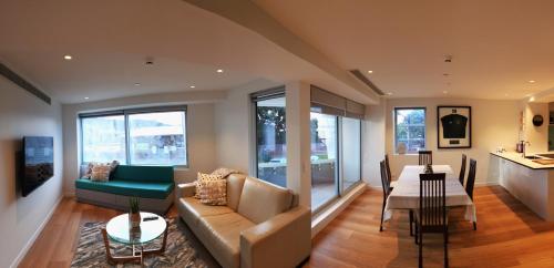 a living room with a couch and a table at U Suites on Oriental Parade in Wellington