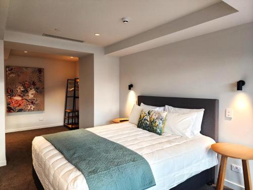 a bedroom with a large bed in a room at U Suites on Oriental Parade in Wellington