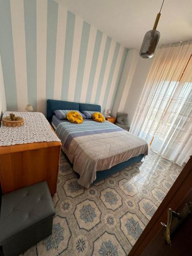 a bedroom with a bed with yellow flowers on it at Appartamento Primavera in Scalea