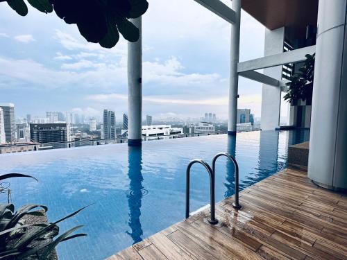 a swimming pool on the roof of a building at The Luxe Colony KLCC By AZHA in Kuala Lumpur