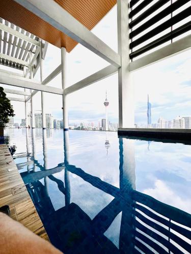 a swimming pool with a view of the city at The Luxe Colony KLCC By AZHA in Kuala Lumpur