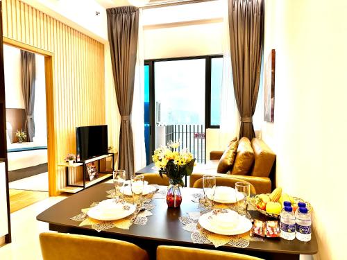 a table in a living room with a dining room at The Luxe Colony KLCC By AZHA in Kuala Lumpur