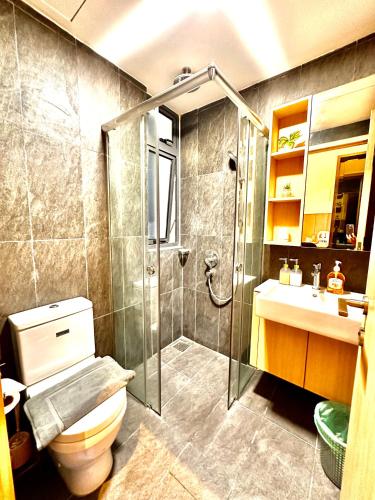 a bathroom with a shower and a toilet and a sink at The Luxe Colony KLCC By AZHA in Kuala Lumpur