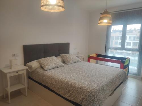 a bedroom with a bed with two pillows on it at Apartamento Sarastur in Posada de Llanes