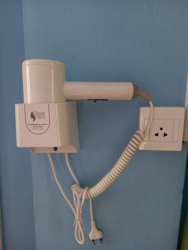 a phone with a cord plugged into a wall at Royal Land Mae Klong Hotel in Samut Songkhram