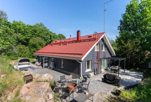 a small house with a deck with a grill at Beautiful house in peaceful area in Vantaa