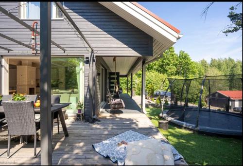 a porch of a house with a table and chairs at Beautiful house in peaceful area in Vantaa